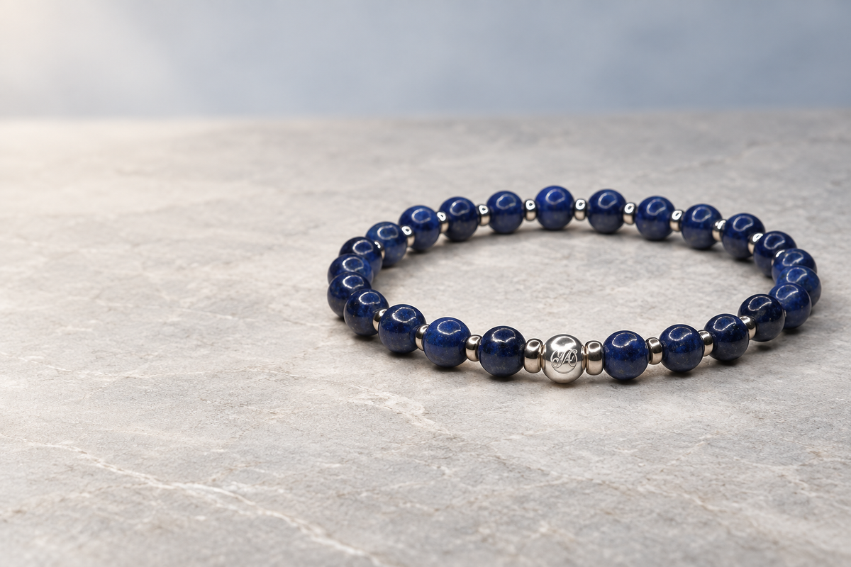 September Sapphire Signature sterling silver bracelet styled on dark blue fabric